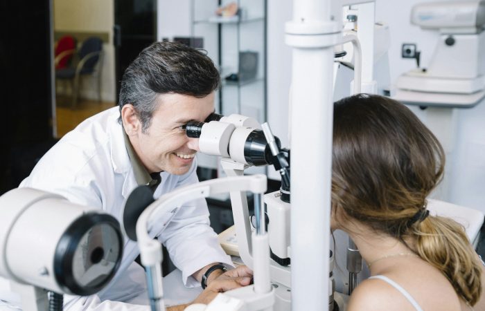 Eye Doctor examinating a young patient