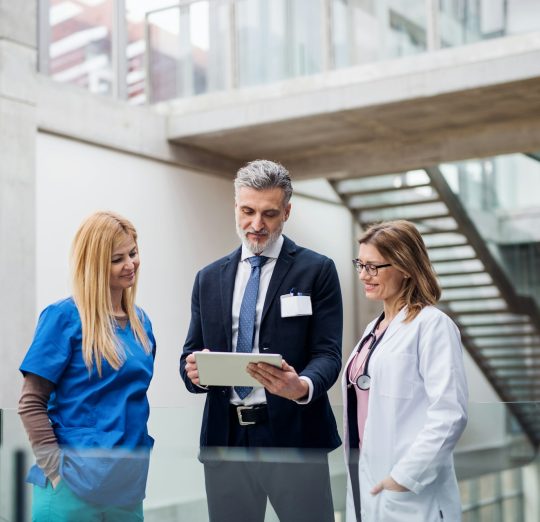 Group of doctors talking to pharmaceutical sales representative