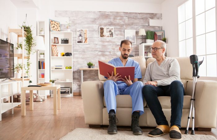 Male doctor in nursing home reading a book