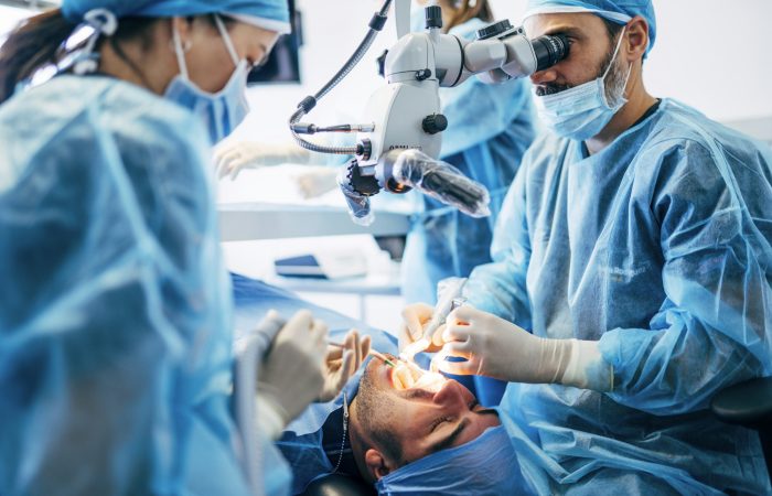 Team dental surgeons working in dental clinic.